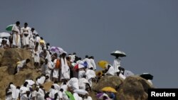 Muslim pilgrims visit Mount Mercy on the plains of Arafat during the annual haj pilgrimage, outside the holy city of Mecca, Sept. 23, 2015. 