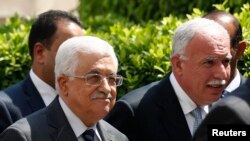 Palestinian President Mahmoud Abbas and his foreign minister Riyad al-Maliki, right, arrive for an Arab League Foreign Ministers emergency meeting, Cairo, Sept. 7, 2014.