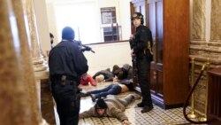 U.S. Capitol Police hold protesters at gun-point near the House Chamber inside the U.S. Capitol on Wednesday, Jan. 6, 2021, in Washington. (AP Photo/Andrew Harnik)