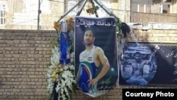 In this image shared widely online, tributes are displayed outside the home of Iranian wrestler Navid Afkari in the city of Shiraz, after Iran executed him on September 12, 2020 for a murder confession that he said was obtained under torture.