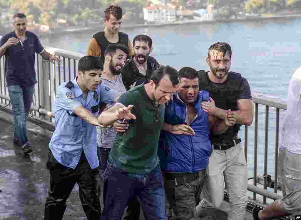 People apprehend a Turkish soldier, who participated in the attempted coup, on Istanbul&#39;s Bosporus Bridge, July 16, 2016.