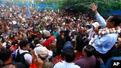 President of National Rescue Party Sam Rainsy, right, gives a speech during his tour visit to Boeung Kak lake area, in Phnom Penh, Cambodia, Monday, Aug. 5, 2013.
