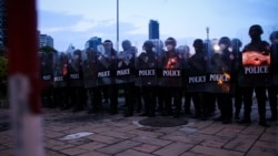 Thai police form a line as protesters march to the German Embassy in Bangkok, Thailand, 14 Nov. 2021 (VOA/Tommy Walker)