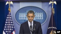 President Barack Obama pauses as he talks about the Connecticut elementary school shooting, in the White House briefing room in Washington, December 14, 2012.