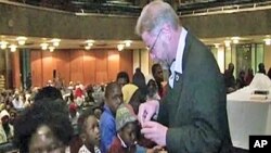 Bishop Paul Verryn offers a blessing to his parishioners in a dimly-lit downtown Johannesburg church
