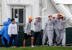 FILE - Migrant children walk on the grounds of the Homestead Temporary Shelter for Unaccompanied Children, June 16, 2019, in Homestead, Fla.