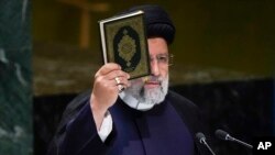 Iran’s President Ebrahim Raisi holds a Quran as he addresses the 78th session of the United Nations General Assembly at United Nations headquarters, Sept. 19, 2023. 
