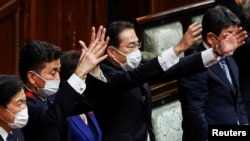 Perdana Menteri Jepang dan pemimpin Partai Demokrat Liberal (LDP) Fumio Kishida dan para menteri kabinetnya mengangkat tangan dan meneriakkan "banzai" setelah pembubaran majelis rendah diumumkan di Parlemen di Tokyo. (Foto: Reuters)