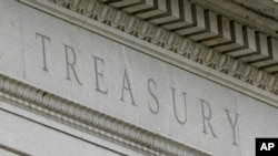 FILE - This May 4, 2021 file photo shows the Treasury Building in Washington. The U.S. Treasury Department said Thursday, May 20, 2021 that it supports a global minimum corporate tax rate of at least 15% — below the 21% minimum it has been seeking…