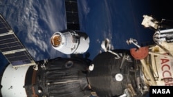 In this photo taken by Russian astronaut Sergey Ryazanskiy, the SpaceX Dragon capsule arrives at the International Space Station on Wednesday, Aug. 16, 2017. The capsule pulled up Wednesday following a two-day flight from Cape Canaveral, Fla. (Sergey Ryazanskiy/NASA via AP)