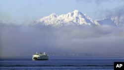 A Washington state ferry emerges from a fog bank on Puget Sound near Bainbridge Island in this 2013 file photo. 