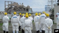 International Atomic Energy Agency (IAEA) inspection team members watch No.3 reactor at the crippled Tokyo Electric Power Co. Fukushima Daiichi nuclear power plant in Fukushima Prefecture, in this handout photo taken and released by TEPCO, (File)