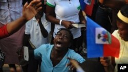 A woman takes part in an open air mass in Port-au-Prince on January 24, 2010. More than 110,000 people have been confirmed as killed in Haiti's devastating earthquake, the Interior Ministry said, making it the deadliest on record in the Americas.