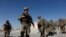 FILE - U.S. troops wait for their helicopter flight at an Afghan National Army (ANA) base in Logar province, Afghanistan, Aug. 7, 2018. 