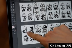 In this Wednesday, October 23, 2019 photo, a client who goes by the single name "Mary" chooses a tattoo image depicting protective gear-wearing protesters from a computer display in Hong Kong.