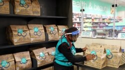 A worker sorts online orders before they are delivered to customers from a Checkers store, amid a nationwide coronavirus lockdown, in Johannesburg, South Africa, July 14, 2020. Picture taken July 14, 2020.