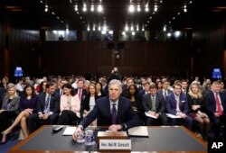 FILE - Supreme Court Justice nominee Neil Gorsuch takes his seat as he arrives on Capitol Hill in Washington, March 21, 2017, for his confirmation hearing before the Senate Judiciary Committee.
