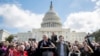 Senate Minority Leader Sen. Chuck Schumer, D-N.Y., holds hands with student activist Matt Post, right, during a student gun control advocates rally outside the Capitol Building in Washington, March 14, 2018. Students walked out of school to protest gun violence in the biggest demonstration yet of the student activism that has emerged in response to last month's massacre of 17 people at Florida's Marjory Stoneman Douglas High School. 