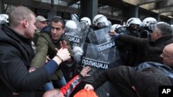 Serbian police scuffle with opposition protesters demanding arrests in connection with a deadly roof collapse at a railway station in Novi Sad, Serbia, Nov. 21, 2024.