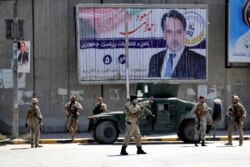 Afghan security forces work at the site of a suicide attack near the U.S. Embassy in Kabul, Afghanistan, Sept. 17, 2019.