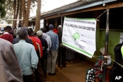 FILE - Kenyan voters line up to cast their votes in the Kibera slum, Nairobi, Kenya.