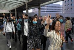 Anti-government office workers attend a lunchtime protest in Hong Kong, Nov. 28, 2019.