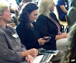 Emily Shumchenia, center, a scientist who consults for the EPA, listens during an environmental workshop, Oct. 23, 2017, in Providence, Rhode Island. Shumchenia helped write a report on the environmental health of Narragansett Bay.