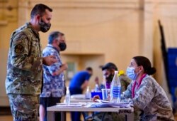 FILE - Hickam 15th Medical Group hosts the first COVID-19 mass vaccination on Joint Base Pearl Harbor-Hickam, Feb. 9, 2021, in this photo provided by the Department of Defense.