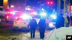 Police officers are seen near a mosque after a shooting in Quebec City, Jan. 29, 2017.