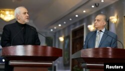 Iranian Foreign Minister Mohammad Javad Zarif, left, speaks during a news conference with Iraqi Foreign Minister Mohamed Alhakim in Baghdad, Iraq, May 26, 2019. 
