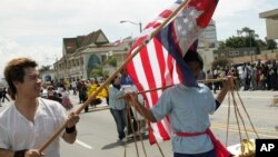 FILE PHOTO - Cambodian Student Society members Sraiph Phan, 21, left, and Danny Sre, 16, march during the Cambodian New Year's Parade in Long Beach Calif., on Sunday, April 24, 2005.