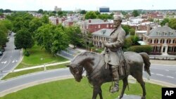 FILE - The statue of Confederate Gen. Robert E. Lee stands in the middle of a traffic circle on Monument Avenue in Richmond, Virginia.