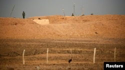 FILE - Moroccan soldiers are seen on an earth wall that separates areas controlled by Morocco and the Polisario Front in Western Sahara, Sept. 10, 2016.