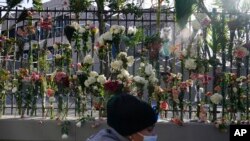 A memorial for the victims of an apartment building fire is displayed in front of the building in New York, Friday, Jan. 14, 2022.