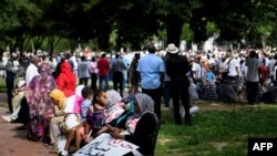 People gather in Lafayette Park, outside the White House in Washington, to protest against the deadly military raid on a nonviolent sit-in in Khartoum, Sudan, June 8, 2019.