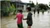 Girls stand in a flooded area of Prek Chrey village, Spean Tmor commune, Dangkoa district, Phnom Penh, Cambodia, on Oct. 15, 2020. (Malis Tum/VOA Khmer)