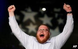 Reid Sheldahl of Des Moines, Iowa, cheers as Democratic presidential candidate Sen. Bernie Sanders, I-Vt., speaks during the Iowa Democratic Party's Jefferson-Jackson fundraising dinner, in Des Moines, Iowa, Oct. 24, 2015.