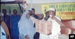 A divorcee trained as a tailor receives a sewing machine as a gift from the Directorate of Employment in Kano. (photo courtesy of VOWAN)