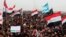 FILE - Sunni protesters chant slogans against the Iraq's Shiite-led government as they wave national flags during a 2013 demonstration in Fallujah.