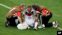 Germany's Christoph Kramer gets assistance during the World Cup final soccer match between Germany and Argentina in 2014. He was allowed to stay in the game.