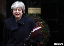FILE - Britain's Prime Minister Theresa May leaves 10 Downing Street in London, Dec. 13, 2017.