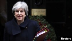 FILE - Britain's Prime Minister Theresa May leaves 10 Downing Street in London, Dec. 13, 2017. 