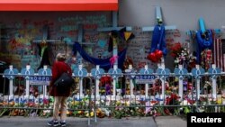 FILE - A woman looks at a makeshift memorial for the victims at Bourbon Street days after a U.S. Army veteran drove his truck into the crowded French Quarter on New Year's Day in New Orleans, Louisiana, Jan. 6, 2025. 