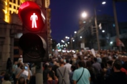 FILE - Journalists gathered during a protest organized by the Group for Media Freedom in front of the government headquarters in Belgrade, Serbia, Oct. 16, 2019.
