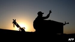 FILE - A member of the Iraqi forces flashes the V for victory sign during military operations in the south and west of the northern Iraqi city of Mosul in search of Islamic State militants, July 11, 2021. 