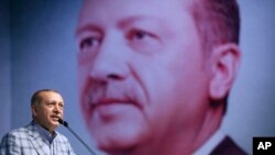 Turkey's President and leader of ruling Justice and Development Party Recep Tayyip Erdogan addresses his party members in Istanbul, June 25, 2017.