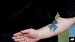 FILE - A neo-Nazi attends a rally in Newnan, Georgia, USA, April 21, 2018. 