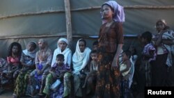 Shofica Belcom, 25, waits with other mothers at a Myanmar Red Cross health clinic near Sittwe, capital of Myanmar's Rakhine state, October 14, 2012.