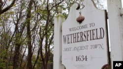 In this Thursday, Nov. 15, 2018, photo a sign declares Wethersfield, Conn., the state's "Most Ancient Town." Experts have unearthed artifacts they believe date to the 1630s in Wethersfield, which has declared itself the state’s “most ancient town,” founded in 1634.