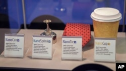 FILE - A sprinkler, tie and coffee cup with hidden cameras are featured at an expo of Israeli intelligence-gathering technology in Tel Aviv, June 30, 2015. Two dozen Israeli companies exhibited their products used by Israeli and international militaries, 